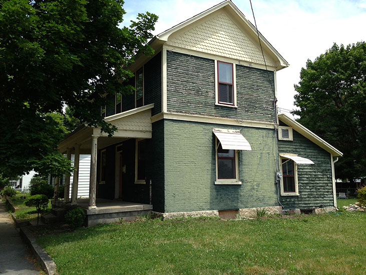 green brick, side yard, scalloped roof trim