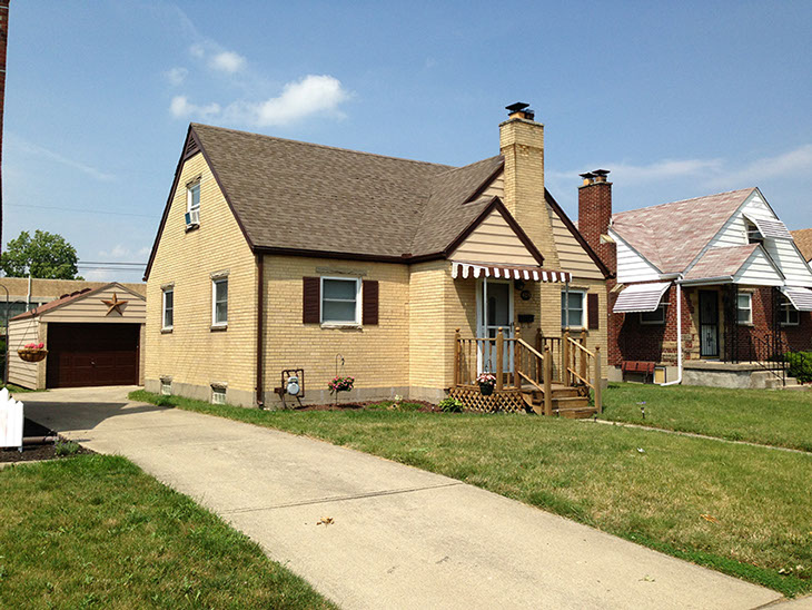 Cape Cod style, driveway, garage in rear