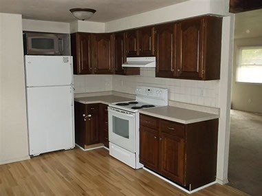 driveway, garage in rear, yellow brick