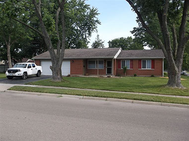 driveway, garage in rear, yellow brick