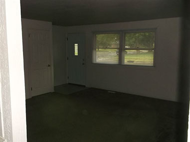 driveway, garage in rear, yellow brick