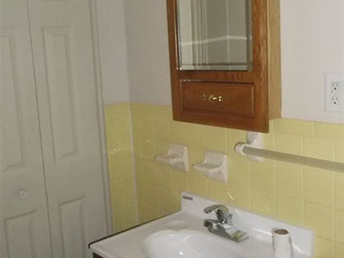 driveway, garage in rear, yellow brick