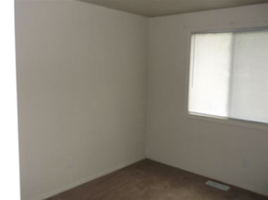 driveway, garage in rear, yellow brick