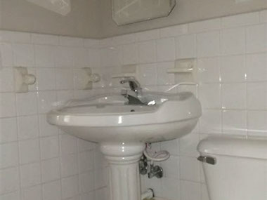 driveway, garage in rear, yellow brick