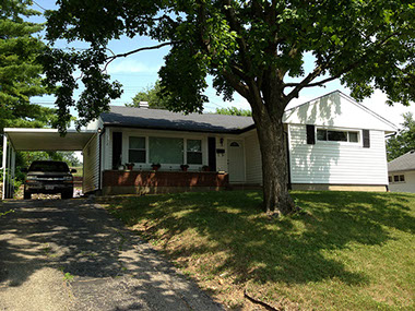 uphill driveway, attached covered car port