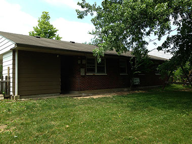 grass, red brick, cream siding