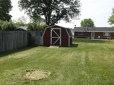 driveway, garage in rear, yellow brick