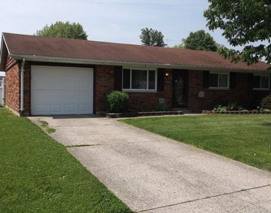 driveway, garage in rear, yellow brick