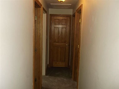 driveway, garage in rear, yellow brick