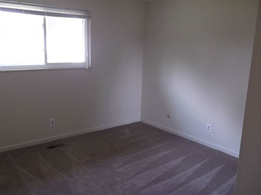 driveway, garage in rear, yellow brick