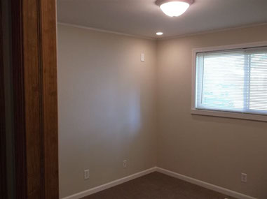 driveway, garage in rear, yellow brick