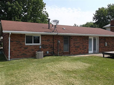 driveway, garage in rear, yellow brick