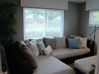 large window, blinds, built-in closet, L couch