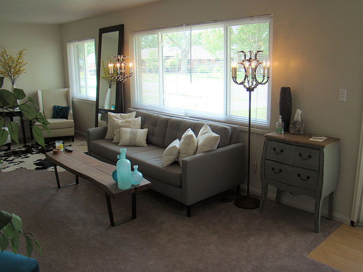 2 large windows, couch, tables, chairs