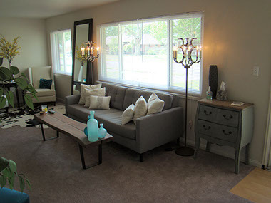 2 large windows, couch, tables, chairs