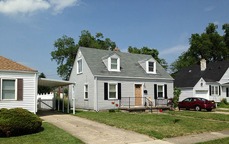 wood door, black shutters, small porch