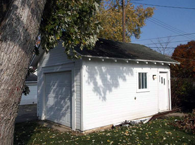 driveway, garage in rear, yellow brick