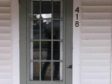 driveway, garage in rear, yellow brick