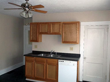 driveway, garage in rear, yellow brick