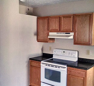 driveway, garage in rear, yellow brick